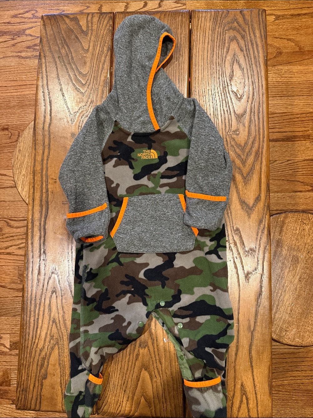 The North Face Kids Camo Hooded Romper with Gray Sleeves and Orange Trim